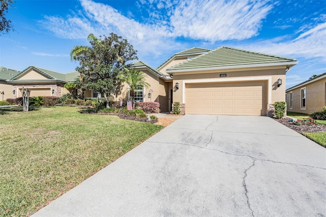 ranch-style home featuring driveway, stucco siding, a front lawn, a garage, and a tile roof