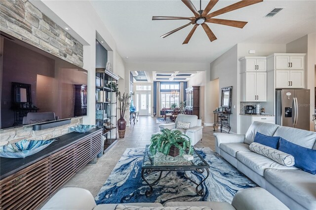 living area with visible vents and a ceiling fan