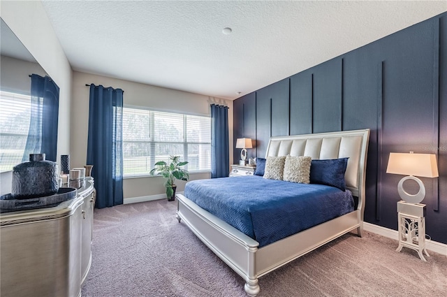 bedroom featuring a textured ceiling, carpet flooring, and baseboards