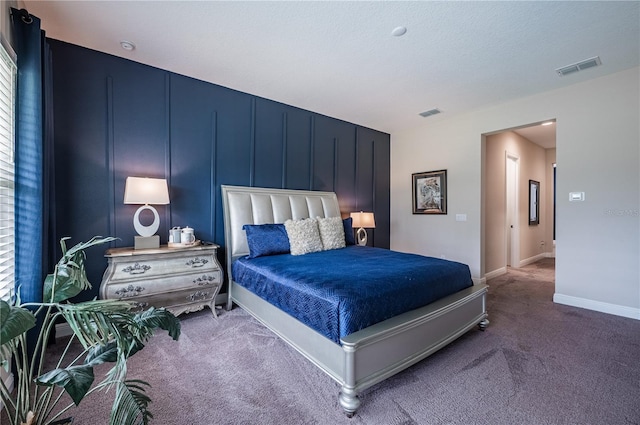 bedroom with carpet, visible vents, and baseboards