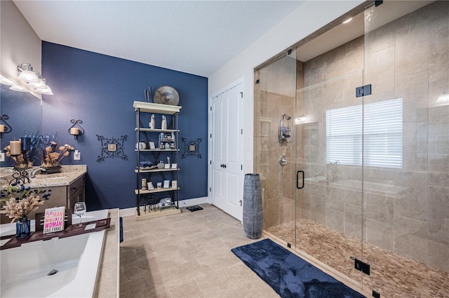 full bath with a stall shower and vanity