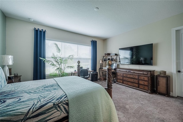 bedroom with a textured ceiling and carpet floors