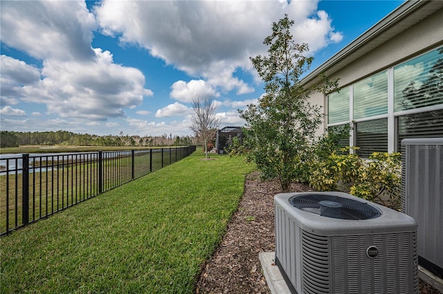 view of yard with fence and central AC unit
