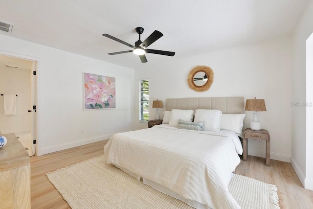 bedroom featuring a ceiling fan, baseboards, visible vents, and light wood finished floors