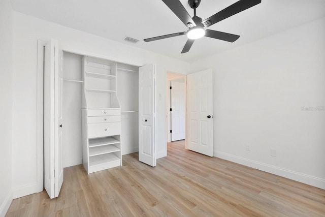 unfurnished bedroom featuring a closet, visible vents, light wood-style flooring, ceiling fan, and baseboards