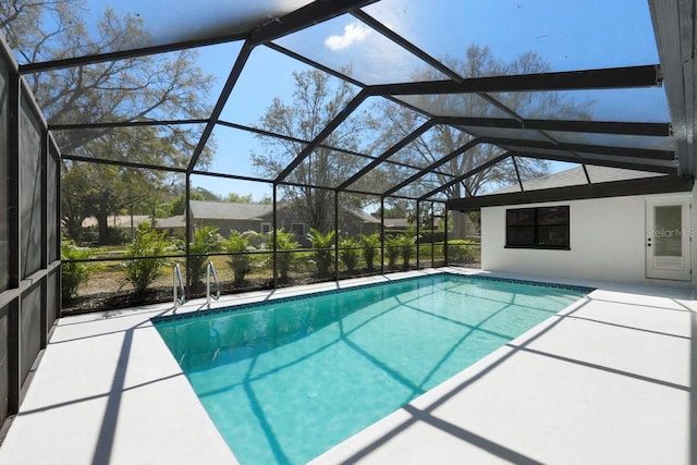 pool featuring a patio area and glass enclosure