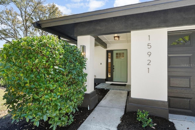 property entrance with stucco siding