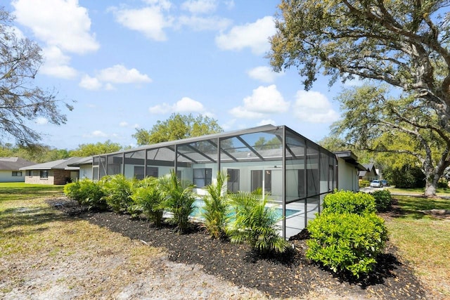 exterior space with glass enclosure and an outdoor pool