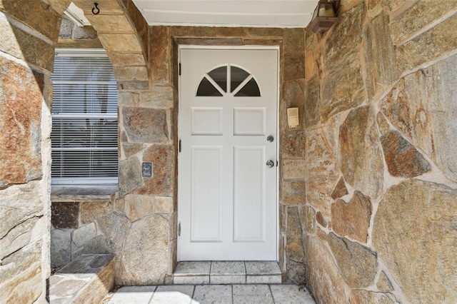 view of exterior entry featuring stone siding