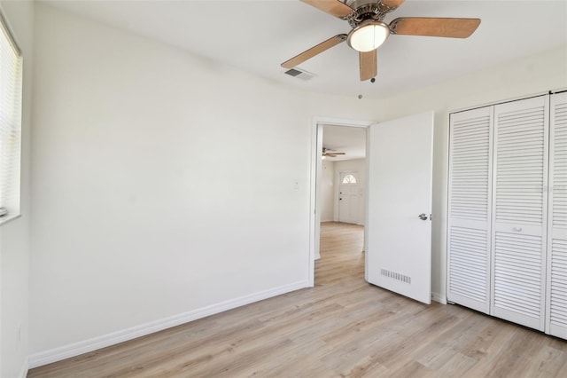 unfurnished bedroom with visible vents, baseboards, ceiling fan, light wood-style floors, and a closet