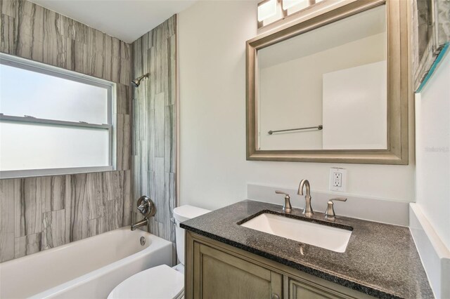 bathroom featuring tub / shower combination, toilet, and vanity