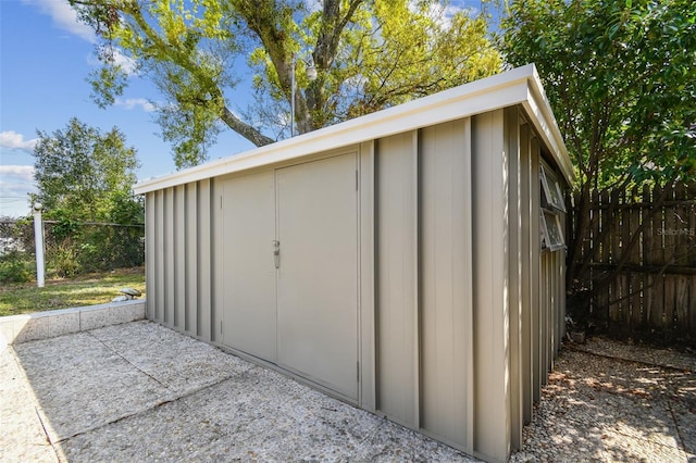 view of shed with fence