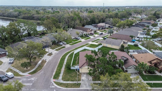 bird's eye view with a water view, a forest view, and a residential view