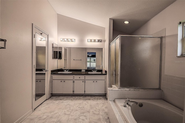 full bathroom featuring double vanity, a shower stall, a sink, and a bath