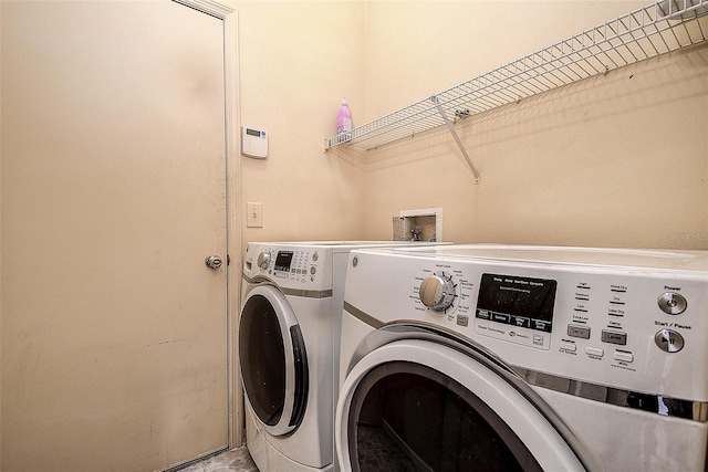 washroom featuring laundry area and washing machine and clothes dryer