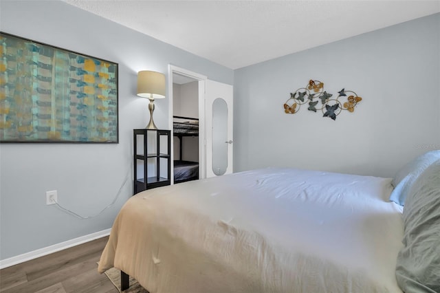 bedroom featuring wood finished floors and baseboards