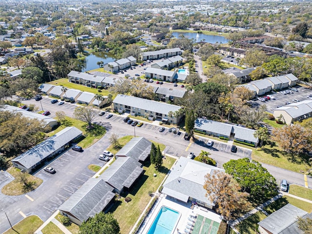 drone / aerial view featuring a residential view and a water view