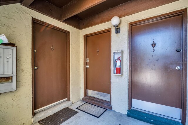 entrance to property featuring stucco siding