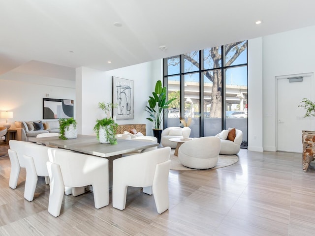 dining room with a wall of windows and recessed lighting