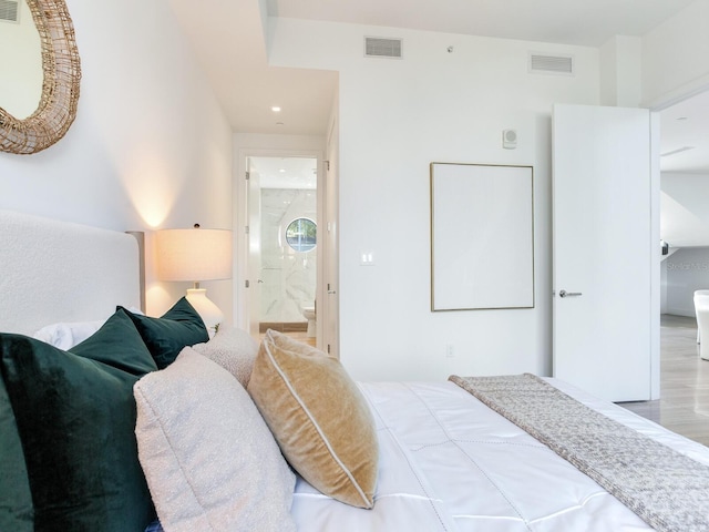 bedroom with ensuite bath and visible vents