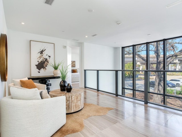 interior space featuring expansive windows, visible vents, and recessed lighting