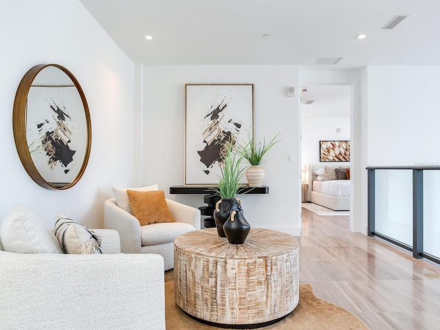 living area with visible vents and recessed lighting