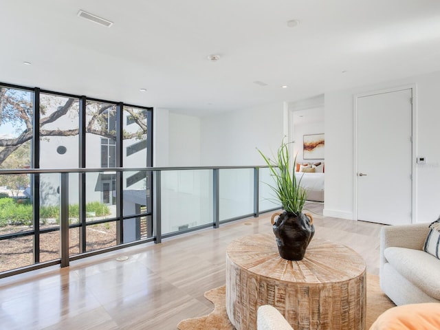 living room featuring expansive windows and visible vents