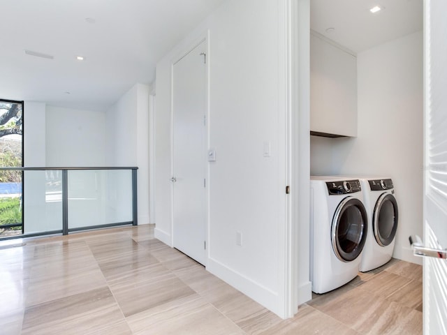 laundry area featuring laundry area, independent washer and dryer, and baseboards