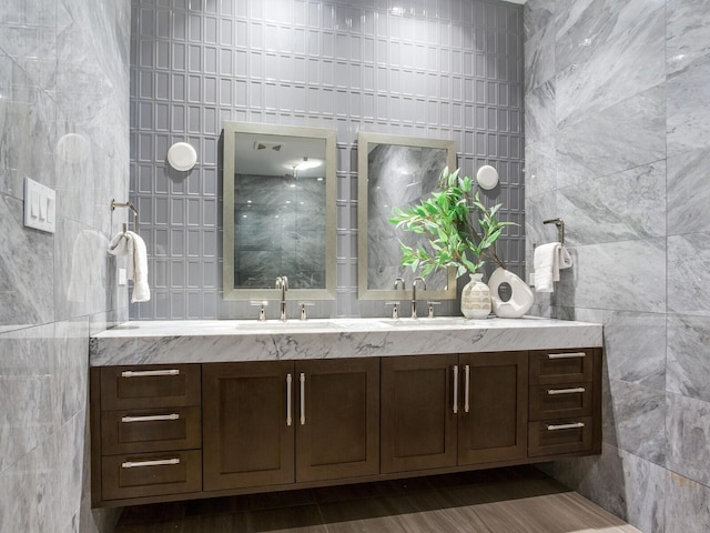 bathroom with tile walls and vanity