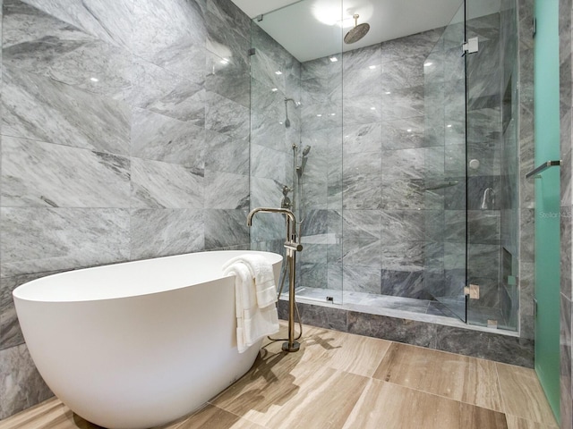 full bathroom featuring a freestanding bath and a stall shower