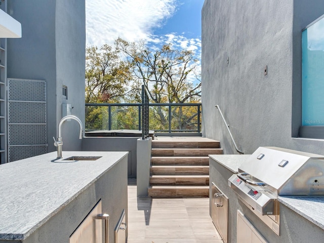 view of patio / terrace featuring a grill, an outdoor kitchen, and a sink