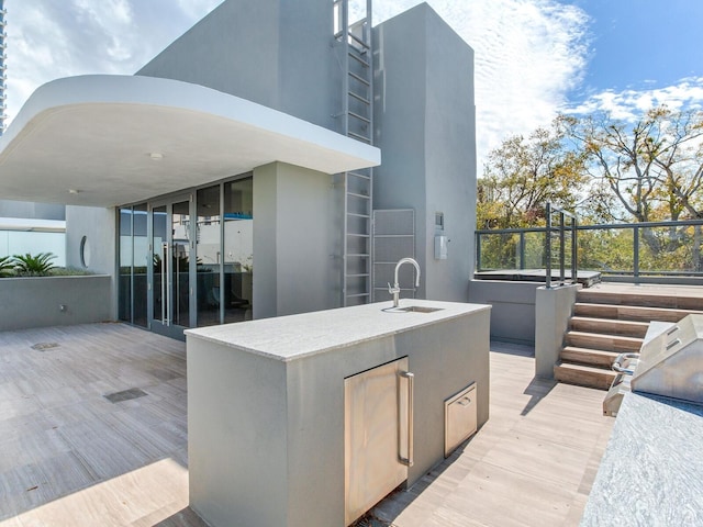 view of patio / terrace featuring a sink and a wooden deck