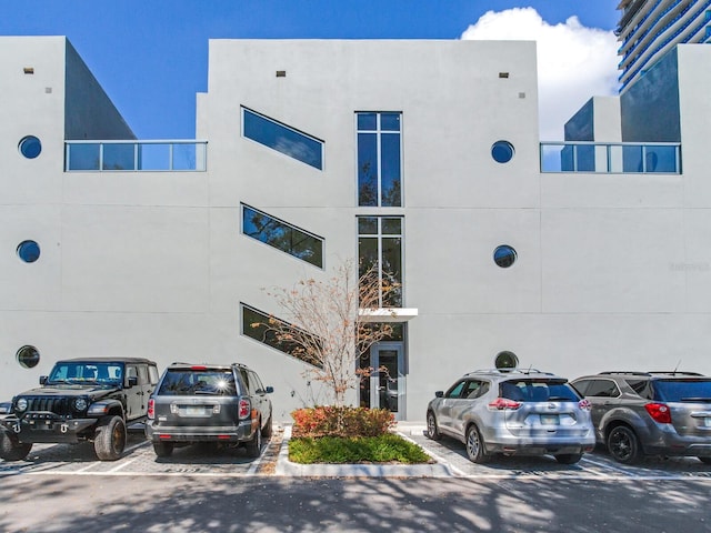 view of building exterior with uncovered parking