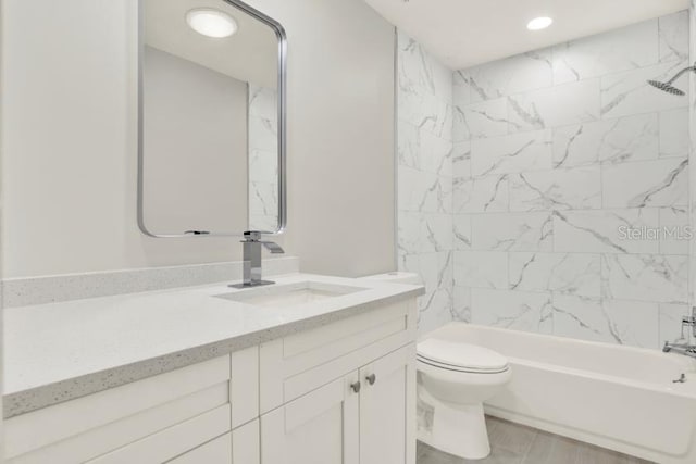 bathroom featuring toilet, shower / bath combination, vanity, and recessed lighting