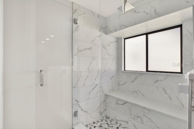 full bath featuring a marble finish shower