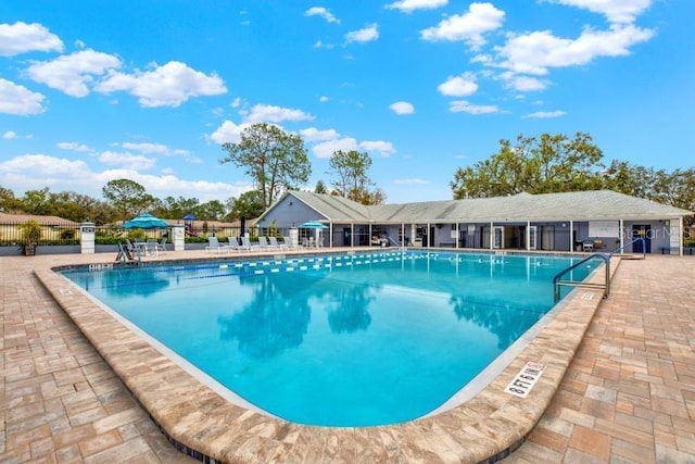 pool featuring a patio and fence