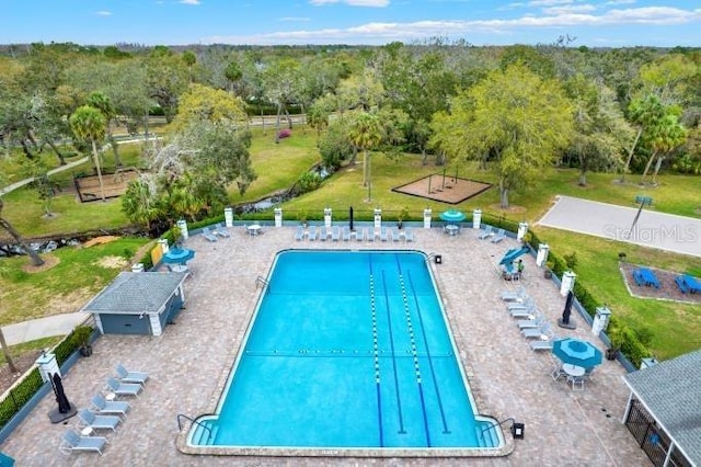 view of swimming pool featuring fence