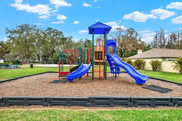 community play area featuring a lawn