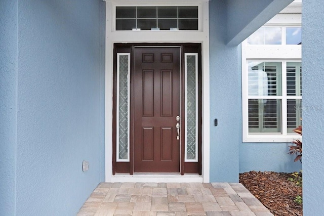 entrance to property with stucco siding