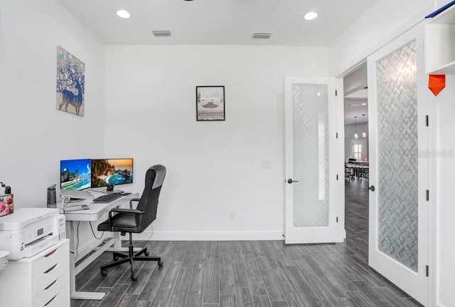 home office featuring baseboards, visible vents, dark wood-style flooring, and french doors