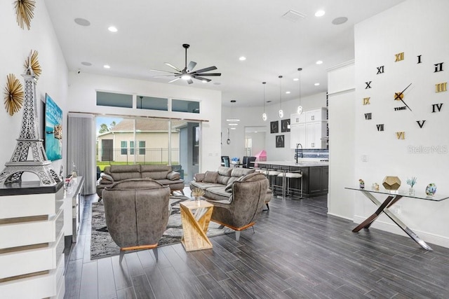 living area featuring dark wood-style floors, ceiling fan, baseboards, and recessed lighting