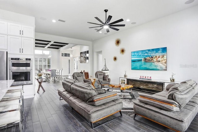 living area with recessed lighting, visible vents, ceiling fan, and wood finished floors