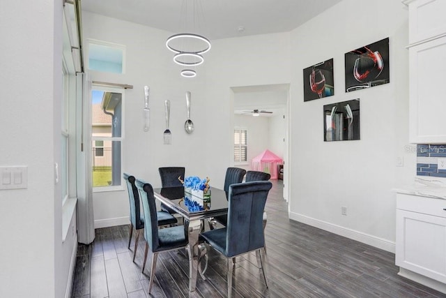 dining space with dark wood-style floors and baseboards