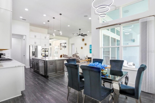 dining area featuring recessed lighting, a healthy amount of sunlight, dark wood finished floors, and ceiling fan