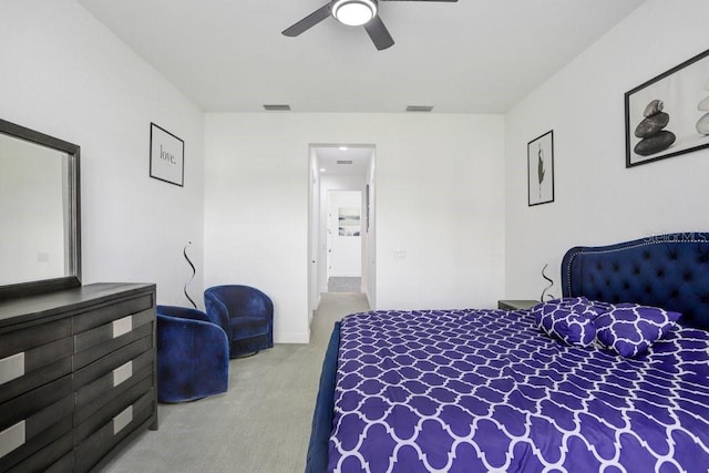 carpeted bedroom featuring visible vents and a ceiling fan