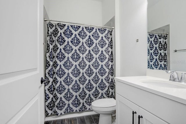 full bath featuring toilet, wood finished floors, vanity, and a shower with curtain