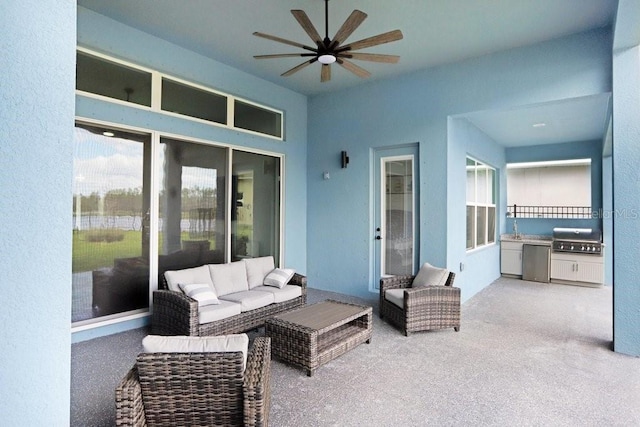 view of patio featuring an outdoor hangout area, area for grilling, a sink, a ceiling fan, and exterior kitchen