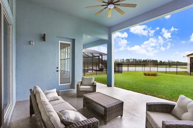 view of patio / terrace featuring a ceiling fan, a lanai, fence, and an outdoor living space