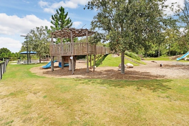 communal playground with fence and a lawn