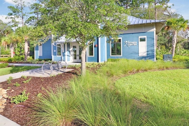 view of property hidden behind natural elements featuring french doors